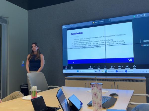 Woman standing in front of a screen